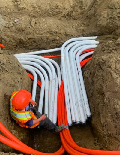 a worker in a trench installing utility lines